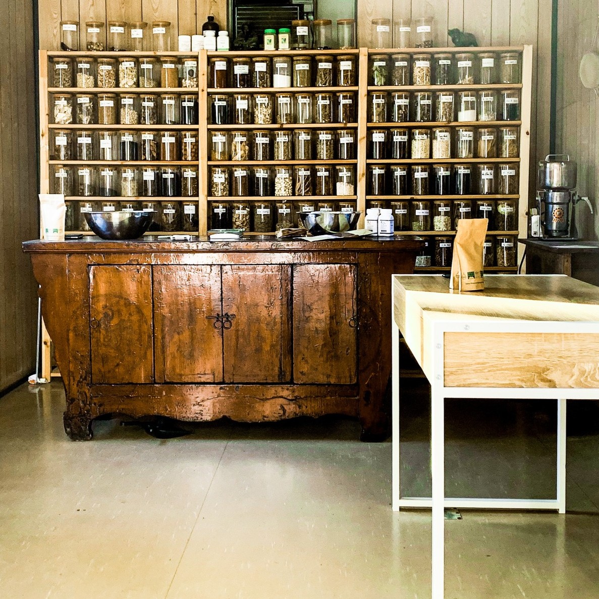 Traditional Chinese Medicine herbal dispensary with antique cabinet and jars of medicinal herbs
